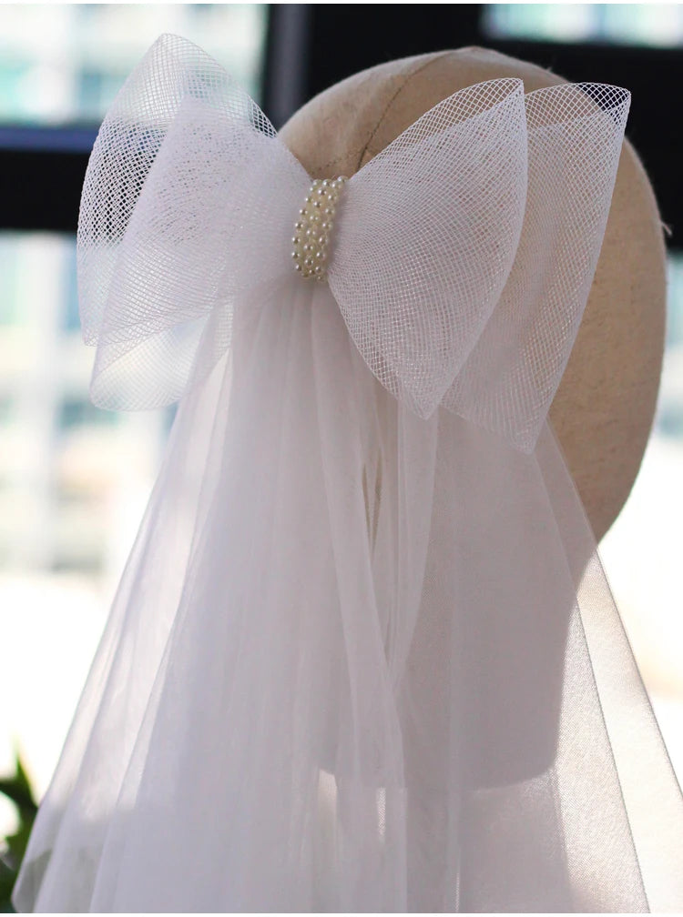 V302 White Bridal Veil with a bow Pearls Bows Multi-Layer Semi-Transparent Tulle Shoulder Length Brides Veil with Hair Comb