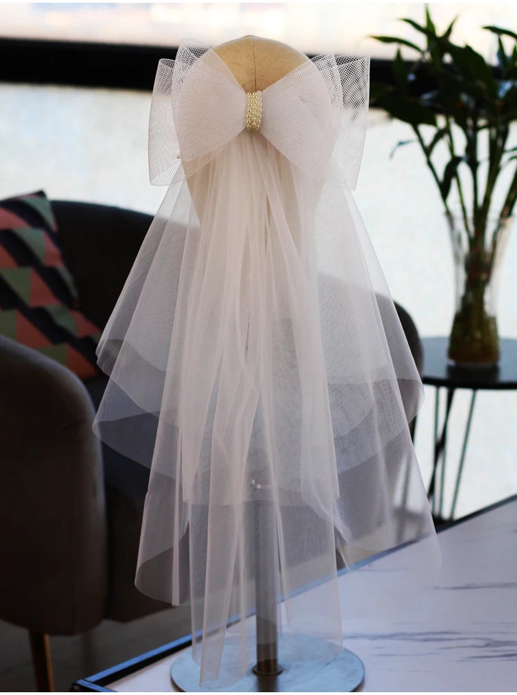 V302 White Bridal Veil with a bow Pearls Bows Multi-Layer Semi-Transparent Tulle Shoulder Length Brides Veil with Hair Comb