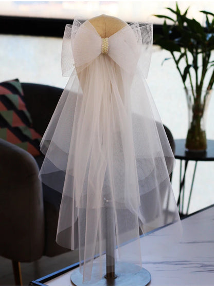 V302 White Bridal Veil with a bow Pearls Bows Multi-Layer Semi-Transparent Tulle Shoulder Length Brides Veil with Hair Comb