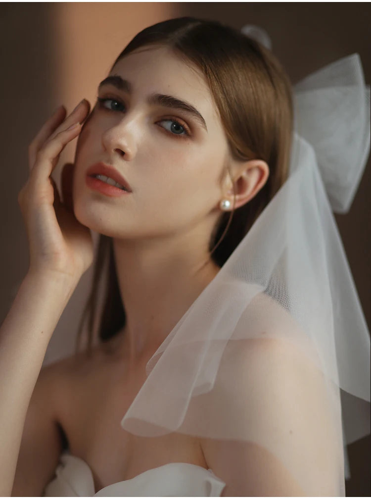 V302 White Bridal Veil with a bow Pearls Bows Multi-Layer Semi-Transparent Tulle Shoulder Length Brides Veil with Hair Comb