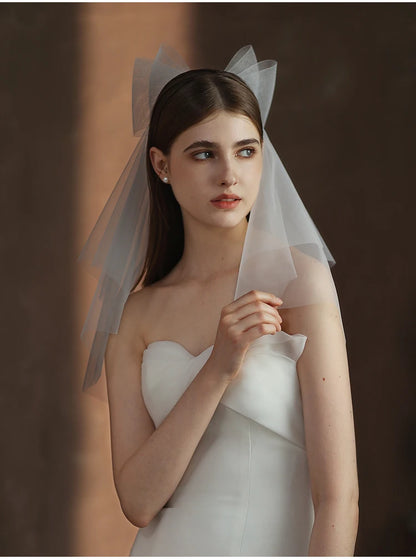 V302 White Bridal Veil with a bow Pearls Bows Multi-Layer Semi-Transparent Tulle Shoulder Length Brides Veil with Hair Comb