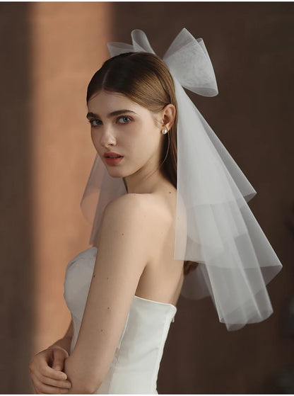 V302 White Bridal Veil with a bow Pearls Bows Multi-Layer Semi-Transparent Tulle Shoulder Length Brides Veil with Hair Comb