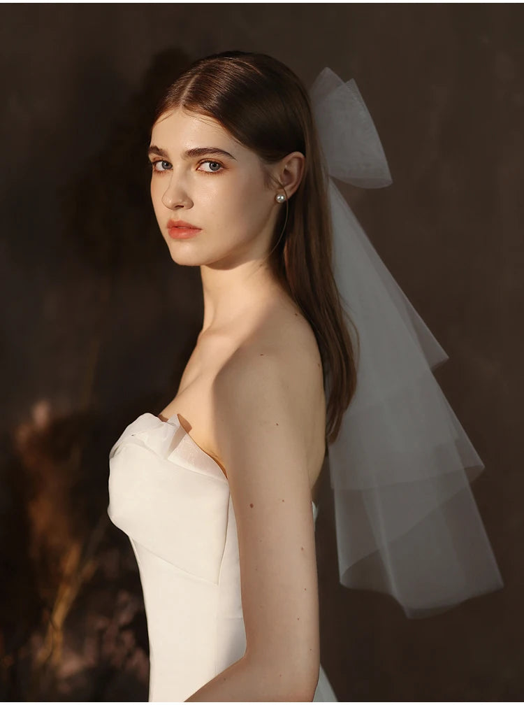 V302 White Bridal Veil with a bow Pearls Bows Multi-Layer Semi-Transparent Tulle Shoulder Length Brides Veil with Hair Comb